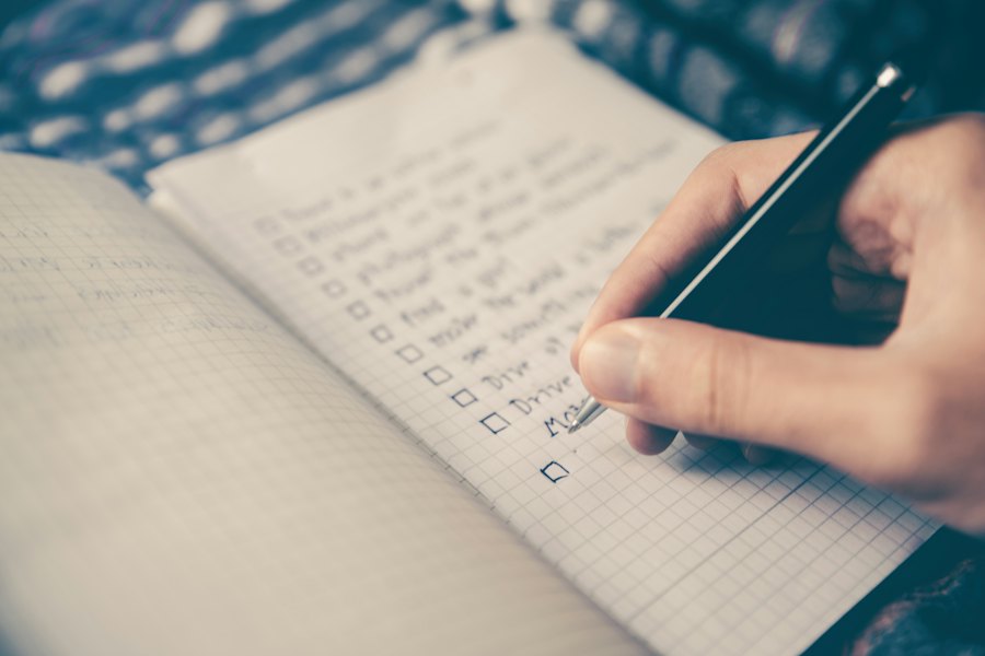 Hand writing a checklist in a notebook